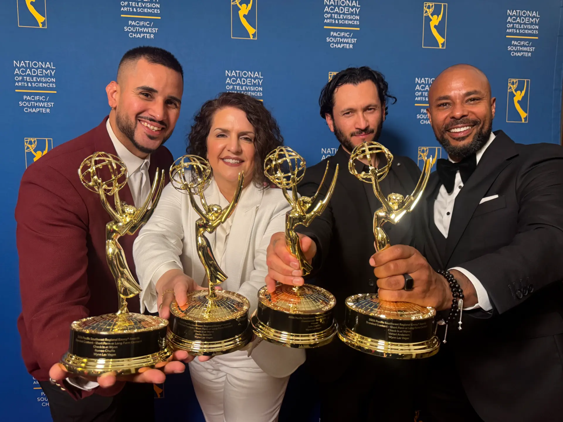 The team holding their Pacific Southwest Emmy awards for Check In at Wynn